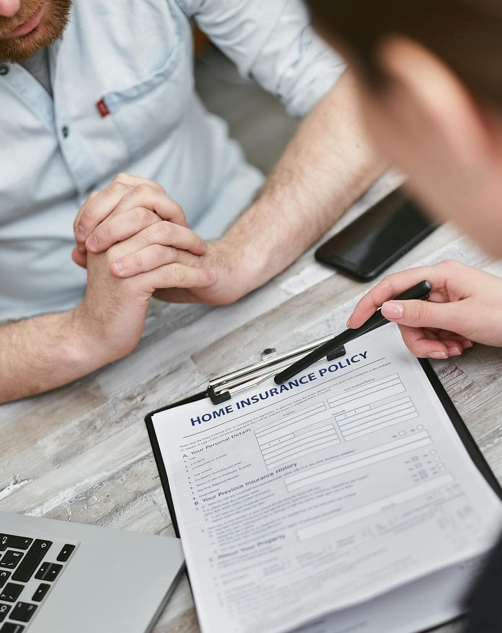close up shot of a person pointing the document on the clipboard