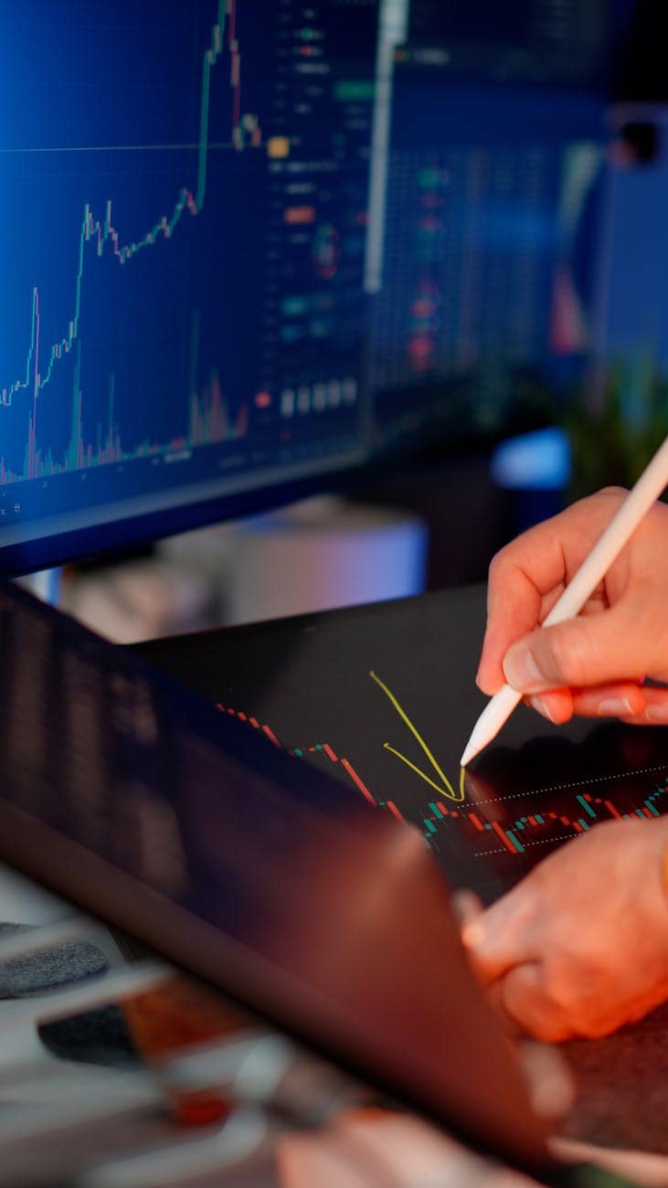 hands using stylus for financial data analysis